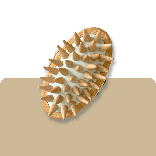 Wooden massagebrush with pointed bristles on a beige background